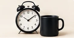 Alarm clock and black mug